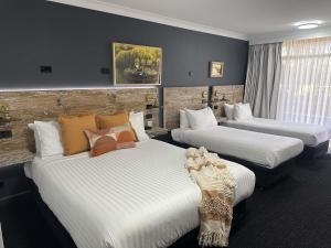 a hotel room with two beds in it at ibis Styles Orange in Orange