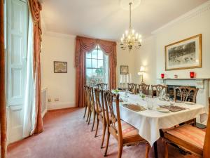 a dining room with a table and chairs at White House Farm in Sedgeford