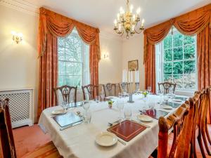 a dining room with a long table and chairs at White House Farm in Sedgeford +32 photos