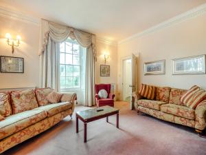 a living room with two couches and a table at White House Farm in Sedgeford