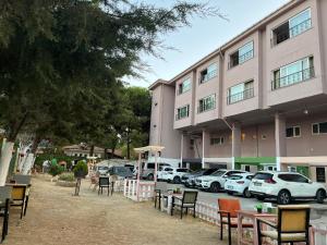 a building with tables and chairs in front of a building at Kumbağ Otel in Kumbağ