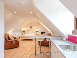 a kitchen and living room with a loft at Spire View in Redlynch +12 photos