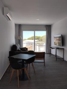 a living room with a couch and a table at Apartamentos y Habitaciones KAI MARBELLA in Marbella
