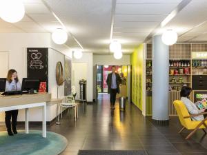 a lobby of a store with people sitting at a counter at Aparthotel Adagio Access Paris Reuilly in Paris