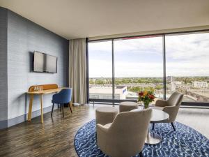a room with a table and chairs and a large window at Mercure Hotel Amersfoort Centre in Amersfoort +96 photos