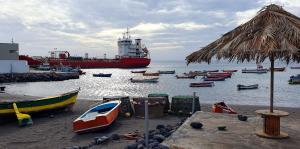 a large boat in the water with many boats at Residência Alto Saco - Studio - Tarrafal de São Nicolau in Tarrafal
