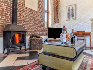 a living room with a fireplace and a stove at St Mary's Chapel in New Buckenham