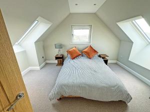 a bedroom with a large bed in a attic at Grianan in Eriskay