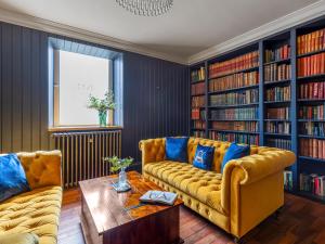 a living room with two couches and a table at Killerby Old Hall - Uk47711 in Cayton