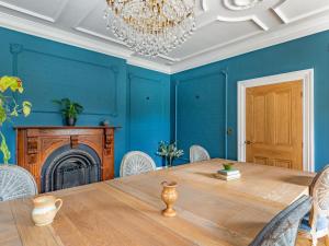 a dining room with a table and a chandelier at Killerby Old Hall - Uk47711 in Cayton +17 photos