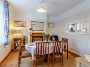 a dining room with a table and chairs at Mayflower Cottage in Harwich