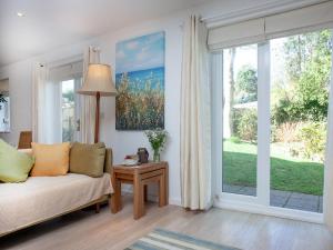 a living room with a couch and a large window at Lark Rise in Northam