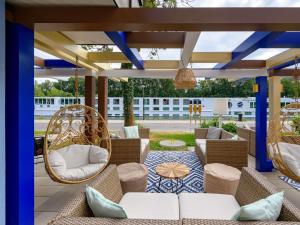 a patio with wicker chairs and wicker swings at Ibis Styles Regensburg in Regensburg