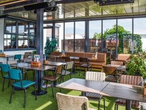 a restaurant with tables and chairs and windows at Marni's Seaview in Heysham +4 photos