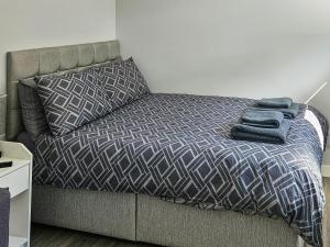 a bed with two towels on it in a bedroom at Harris - Uk34048 in Stornoway