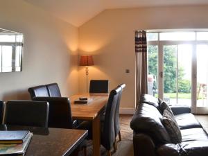a dining room with a wooden table and leather chairs at Durham Cottage-27765 in Wolsingham