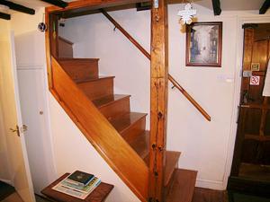 a staircase in a house with a book on a table at Bridge Cottage in Watchet