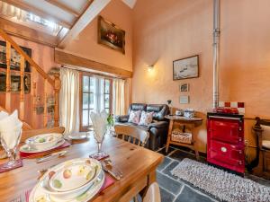 a living room with a table and a couch at Y Cartws in Llanybydder