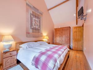 a bedroom with a bed and a tv on a wall at Y Cartws in Llanybydder +19 photos