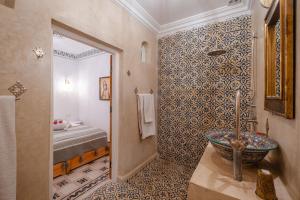 a bathroom with a tub and a sink in a room at Riad fabi in Marrakech +121 photos