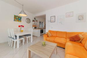 a living room with a couch and a table at Beach House Kocer in Pirovac