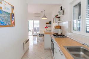 a kitchen with a sink and a counter top at Beach House Kocer in Pirovac +30 photos