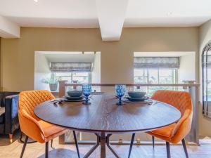 a dining room with a wooden table and chairs at Frenchgate Mews in Richmond