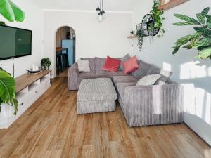 a living room with a couch and a flat screen tv at The Annex At Tenniside in Perranporth +12 photos