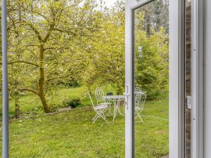 a sliding glass door with a table and chairs outside at The Retreat in Pandy