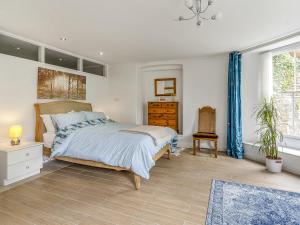 a bedroom with a bed and a dresser and a window at The Retreat in Pandy +15 photos