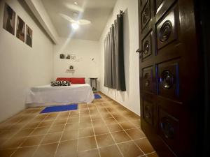 a room with a bed and a room with a door at Térreo Praia Grande in Arraial do Cabo