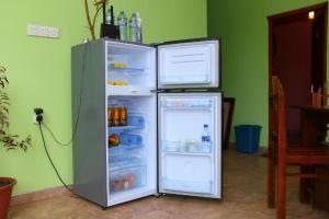 a refrigerator with its door open in a room at Little heaven guest in Ella