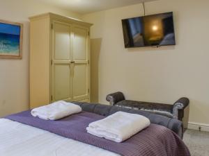 a bedroom with a bed with two towels on it at Sailing By in Carnforth