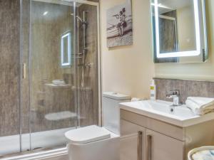 a bathroom with a shower and a toilet and a sink at Sailing By in Carnforth +5 photos