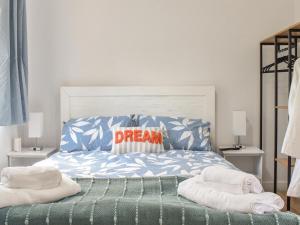 a bed with a dream pillow on top of it at Puffin Cottage in Amble