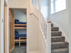 a hallway with stairs leading to a bedroom at Corner Farm - Uk41369 in Carnaby
