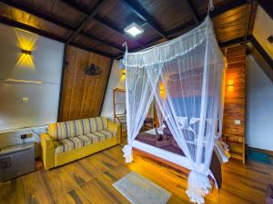 a living room with a couch and a canopy at Ella Happy View Homestay in Ella