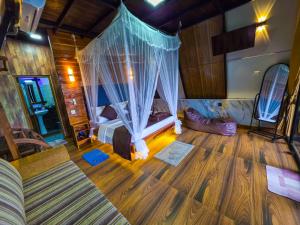 a bedroom with a bed with a canopy at Ella Happy View Homestay in Ella