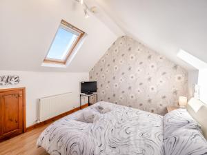 a bedroom with a large bed in a attic at Coastal Retreat in Lowestoft