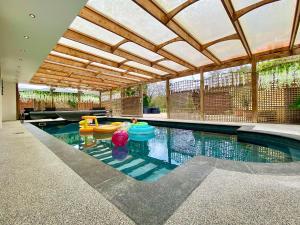 an indoor swimming pool with inflatables in a house at Magnolia Lodge-Uk46280 in Camerton