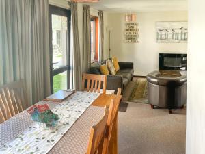 a living room with a table and a couch at Trevithick Lodge in Hayle +4 photos