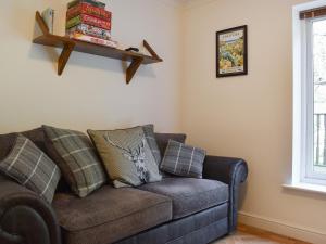 a living room with a couch and a window at Pilot Me Cottage in Staithes