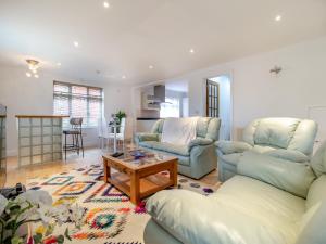 a living room with two couches and a table at The Great Escape in Ipswich