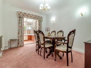 a dining room with a table and chairs at The Great Escape in Ipswich