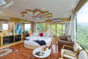 a bedroom with a bed and a living room at Parakkat Nature Resort in Munnar