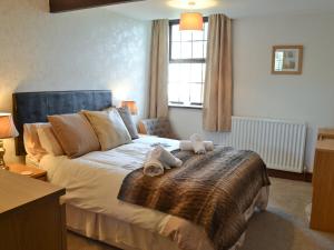 a bedroom with a bed with two towels on it at The Old School in Durham +10 photos