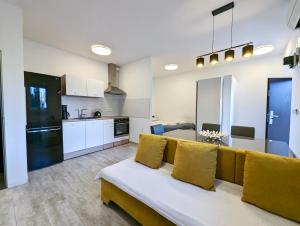 a living room with a couch and a kitchen at Funktastic Central Maksimir Condo in Zagreb