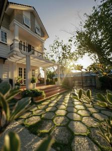 a house with a stone walkway in front of it at De Brume Villa in Da Lat