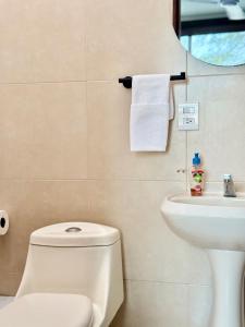 a bathroom with a toilet and a sink at Comfortable Apt near the Beach in Santa Cruz Huatulco