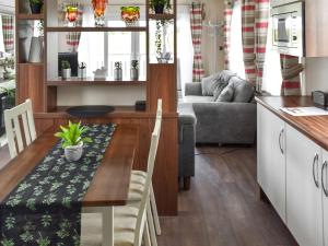 a kitchen and living room with a table and a couch at The View in Whitstable
